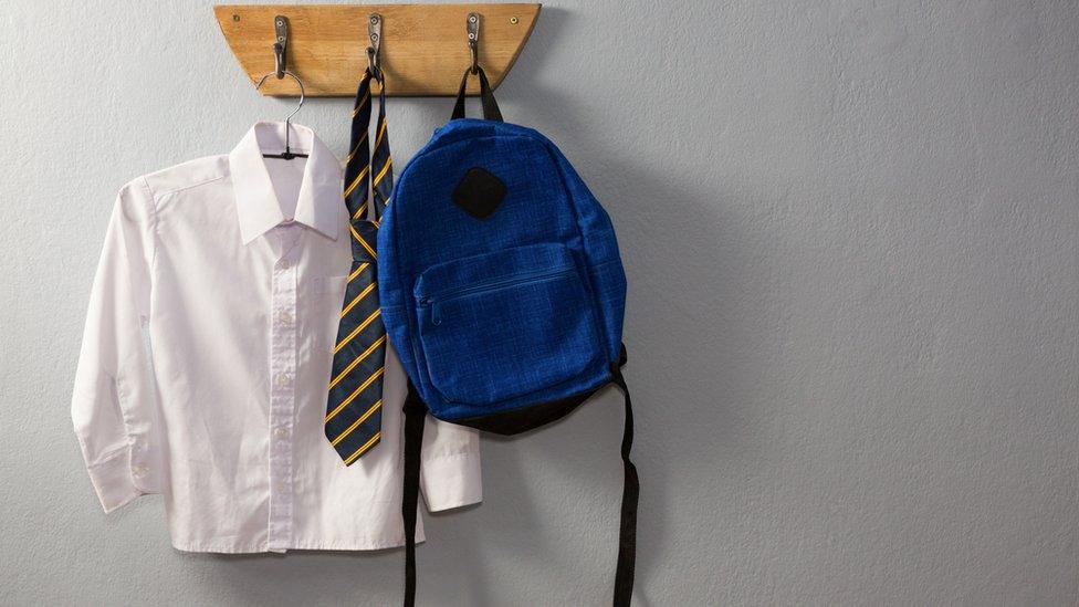 School uniform hanging on pegs