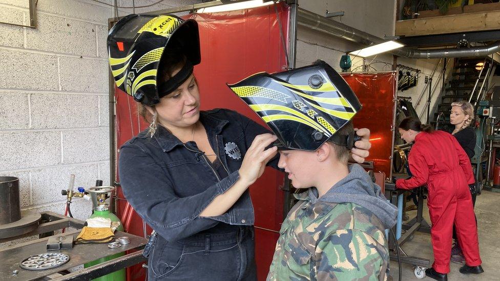 Woman and young boy wearing protective helmets