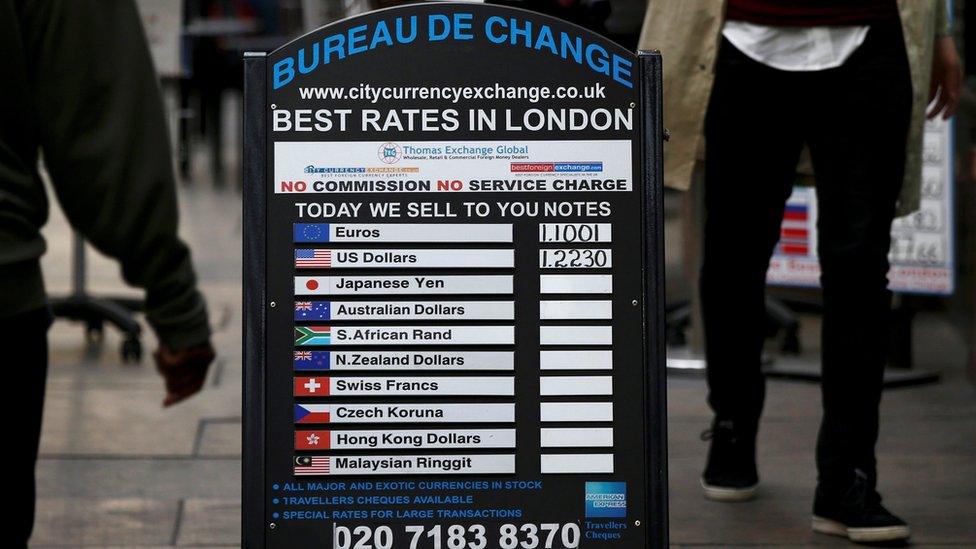 A bureau de change advertises its" rates on board in London, Britain October 7, 2016