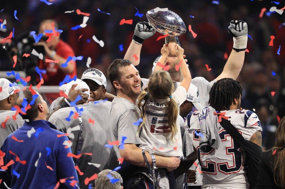 Players lift Super Bowl trophy