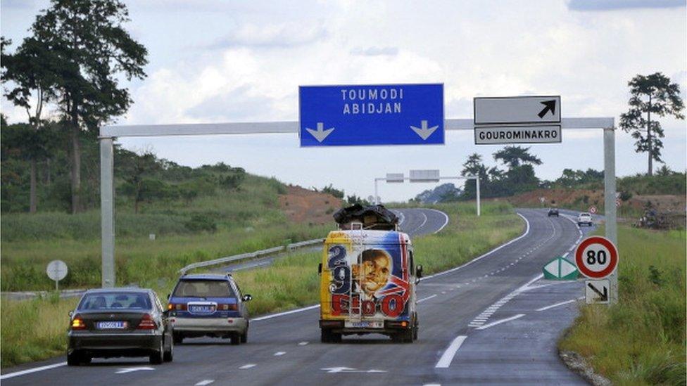 People drive their vehicles on the new 230 km long Abidjan-Yamoussoukro highway on May 11, 2014.