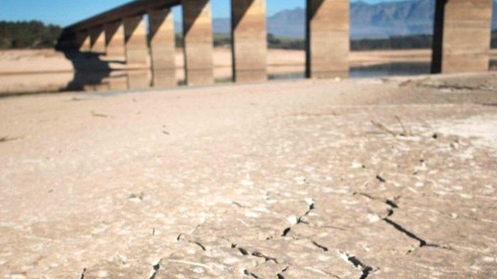 A picture taken on May 10, 2017 shows dry cracked mud staring out at the sky at Theewaterskloof Dam