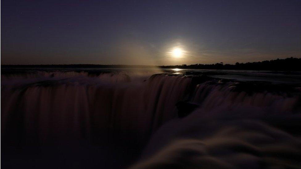 Buck Moon rising behind the Iguazu Falls, on the Argentine side of the Iguazu River