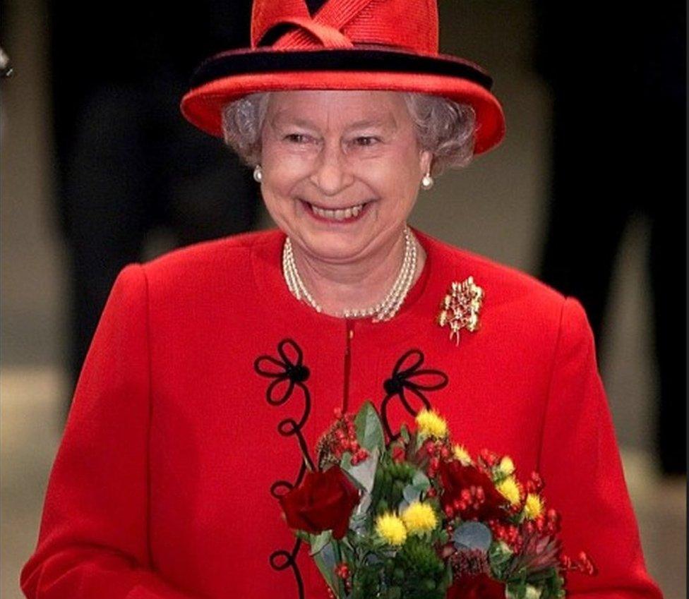 The Queen in a red suit