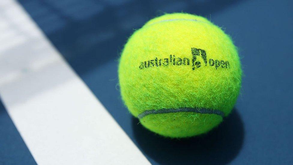 tennis ball with Australian open written on it