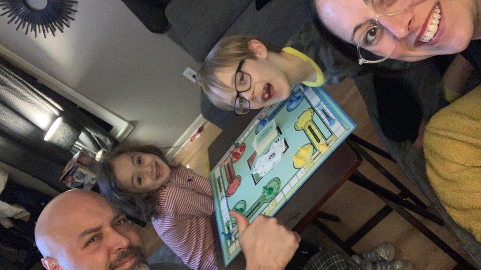 Craig Stanzak and his children Kaitie, four, and Calvin, seven, and his wife, Kristin, play games at home