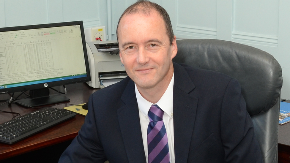 Headmaster John Russell at desk