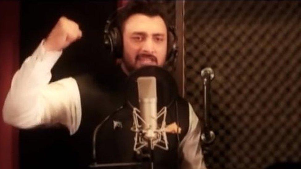 A singer raises his fist in the music video for the Kashmir Anthem Song