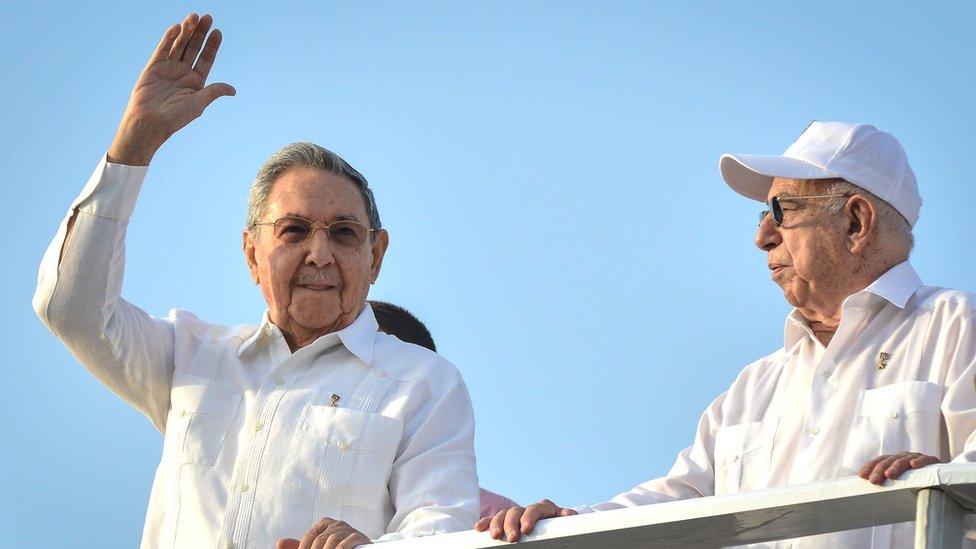 Cuban President Raul Castro (L), next to Vice-president Jose Ramon Machado Ventura, waves in Havana, on May 1, 2014