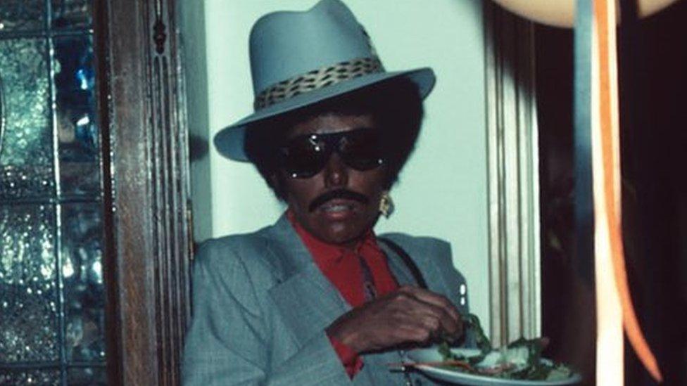 Joni Mitchell (right), in blackface, at a party with Henry Diltz's wife