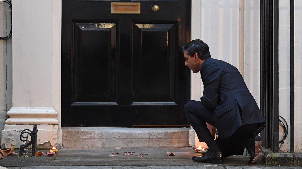 Rishi Sunak lighting candles outside 11 Downing Street to mark the festival