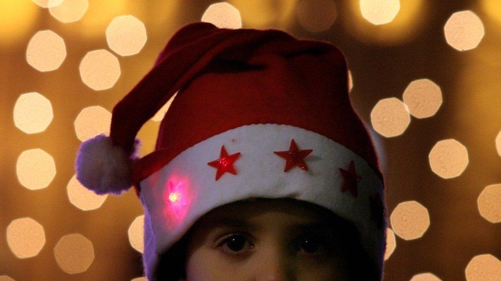 A child attend a ceremony of lighting up the capital's biggest Christmas tree in Sofia