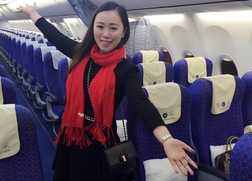 Ms Zhang poses in the empty cabin