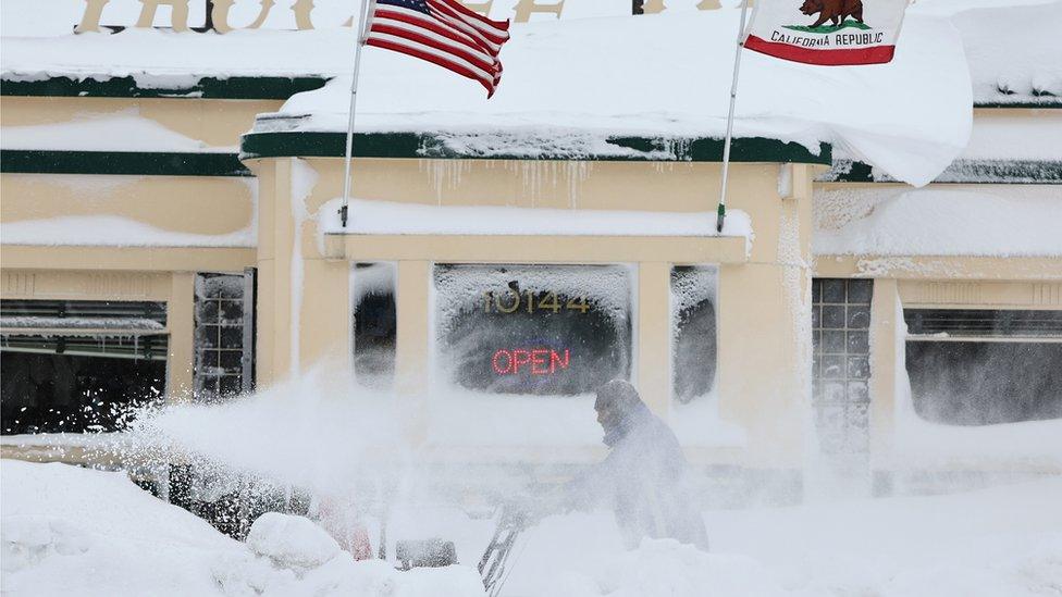 A man struggles to clear snow in Truckee, California. Photo: 2 March 2024