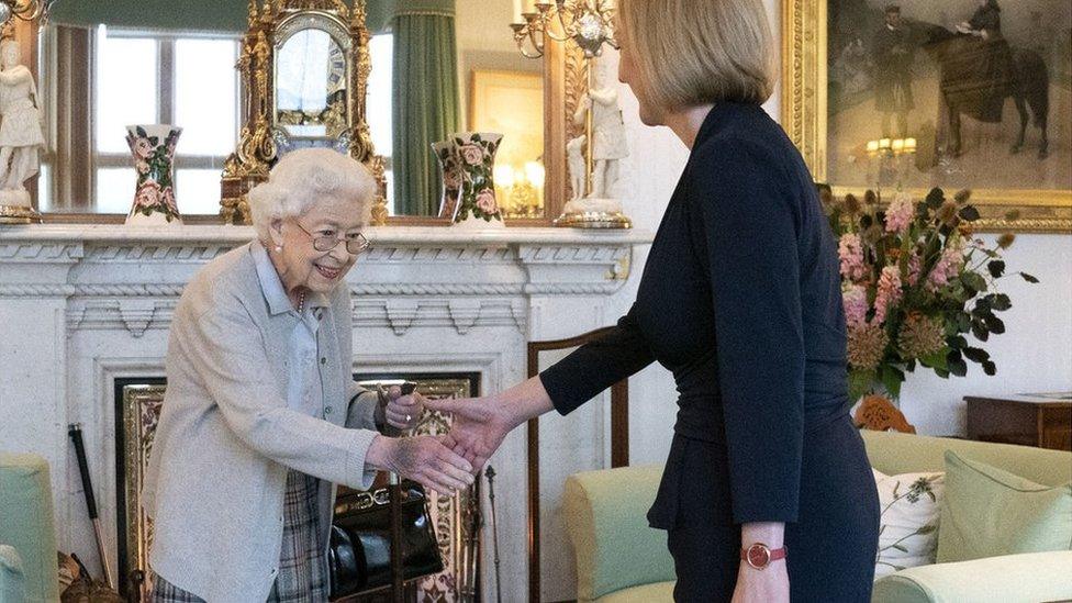 the queen shakes hands with prime minister liz truss