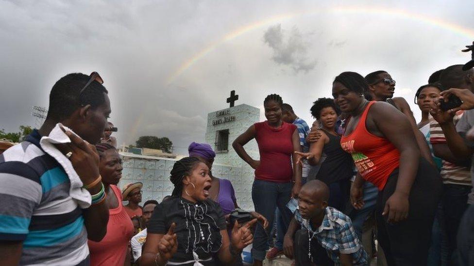 A rainbow is seen above devotees during ceremonies honouring the Haitian voodoo spirits of Baron Samdi and Gede on the Day of the Dead in Port-au-Prince, Haiti on 1 November 1, 2015