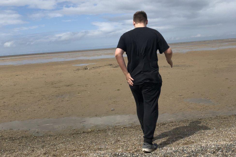 Boy walking on a beach