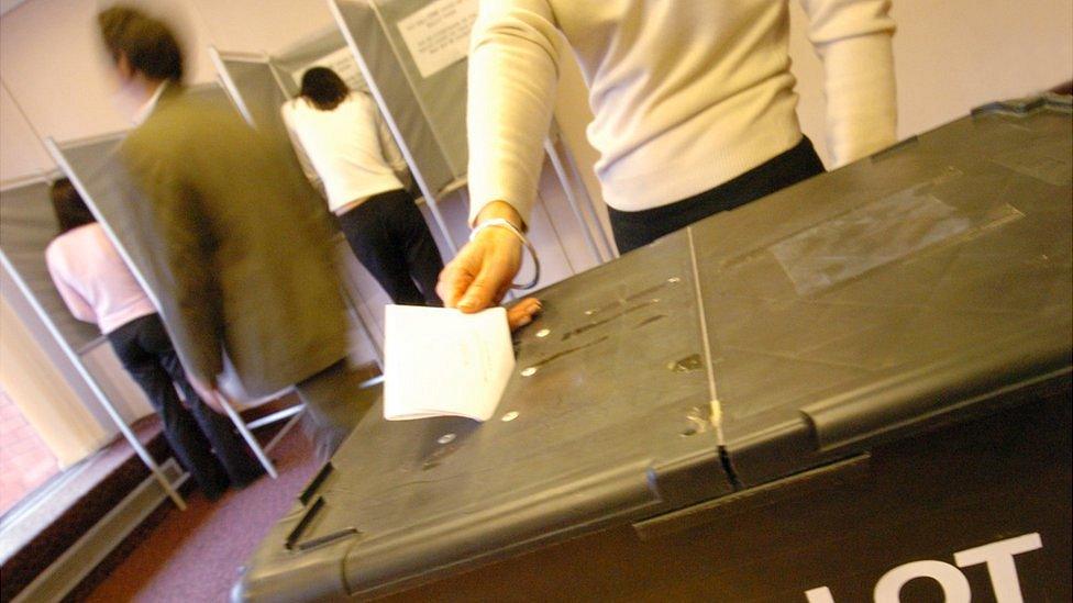 Polling station with voting booths and ballot box