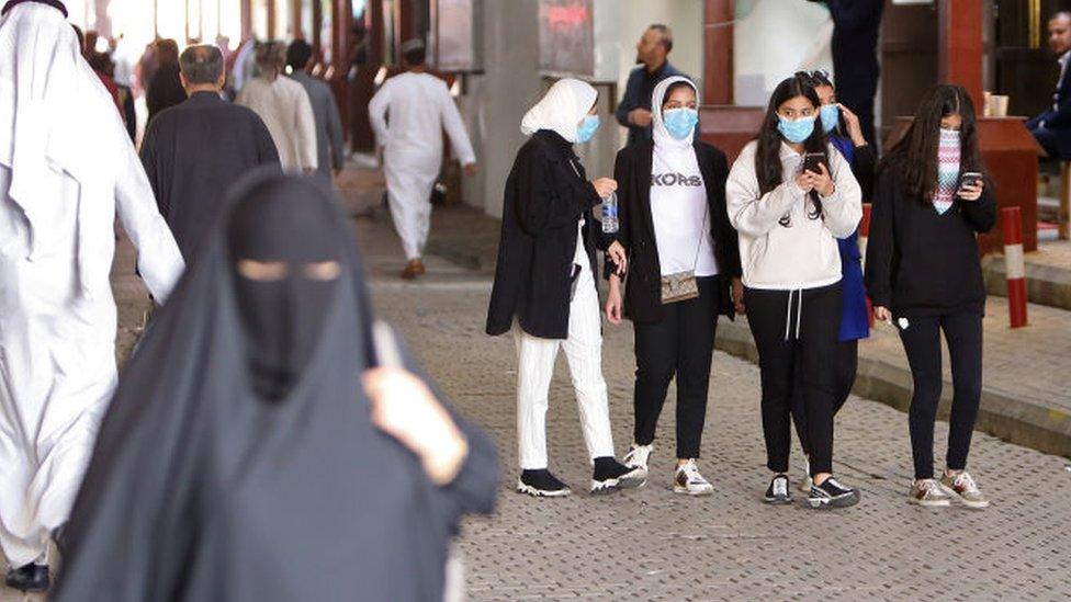 Women walk through a market in Kuwait City (file photo)