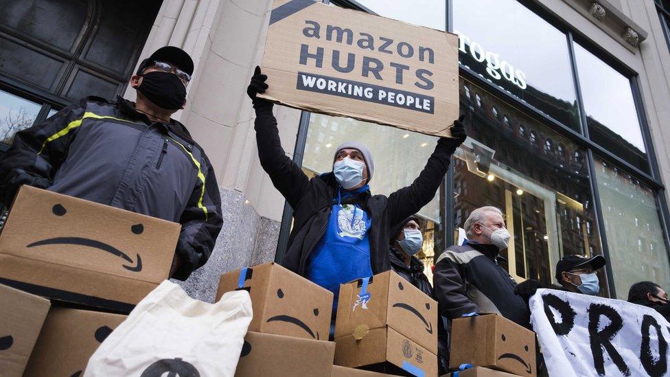 People gather outside of the building where Amazon CEO Jeff Bezos owns an apartment for a protest against the company"s treatment of its workers in New York, New York, USA, 02 December 2020