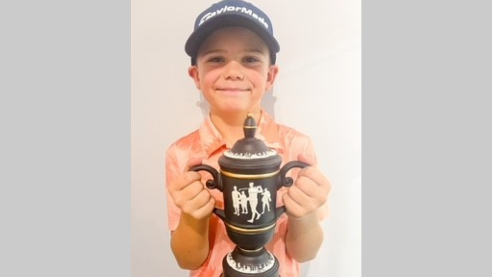 Zachary holding his trophy