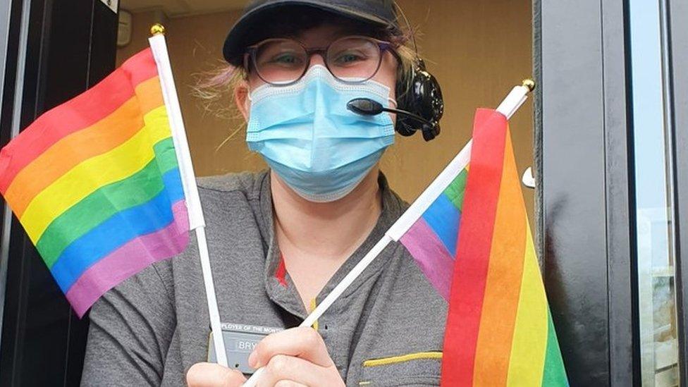 A woman waving Pride flags