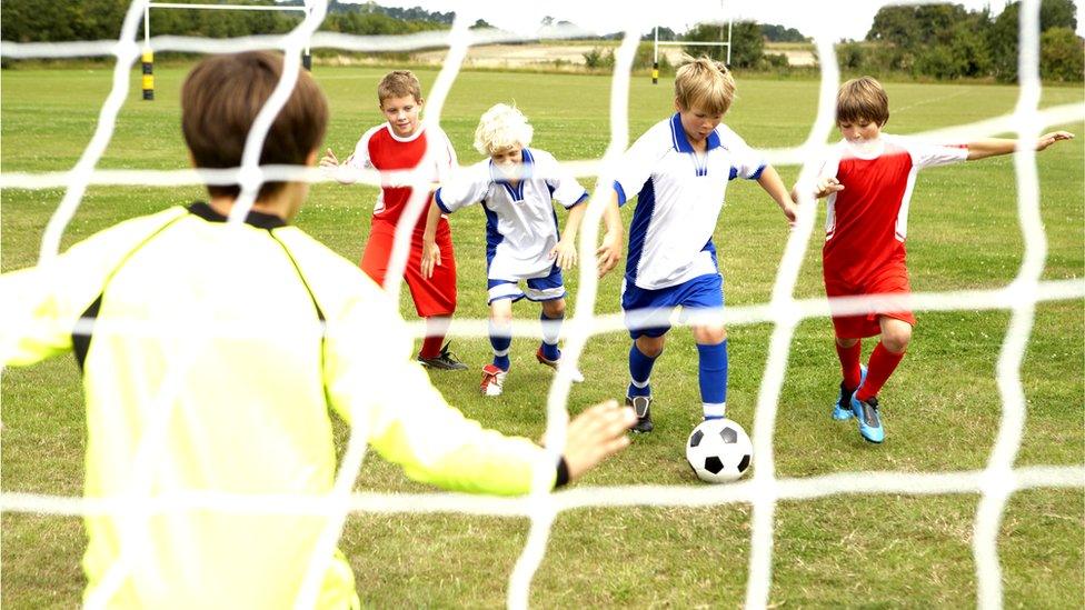 young boys play football