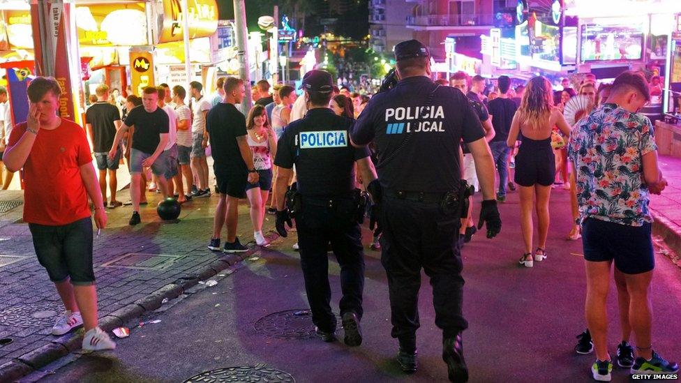 Spanish police patrolling in Magaluf where drinking in the streets has been banned.