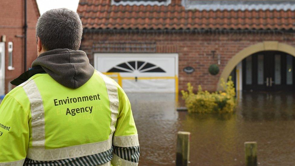 Environment Agency staff check on the rising floodwaters in East Cowick, northern England on March 1, 2020 after Storm Jorge brought more rain and flooding to parts of the UK