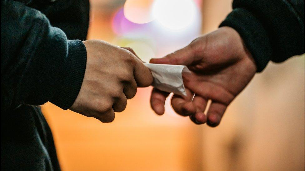 Man Buying Drugs On The Street - stock photo