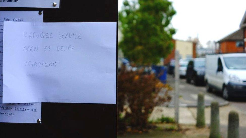 Sign at Red Cross refugee centre saying "open as usual"