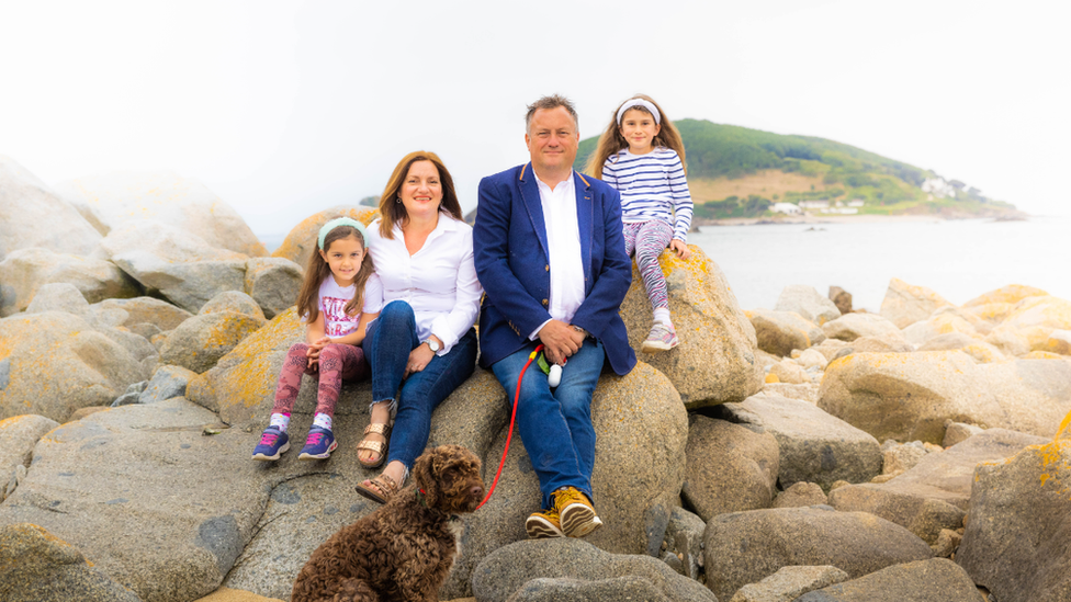 Craig Senior with his wife, two daughters and dog