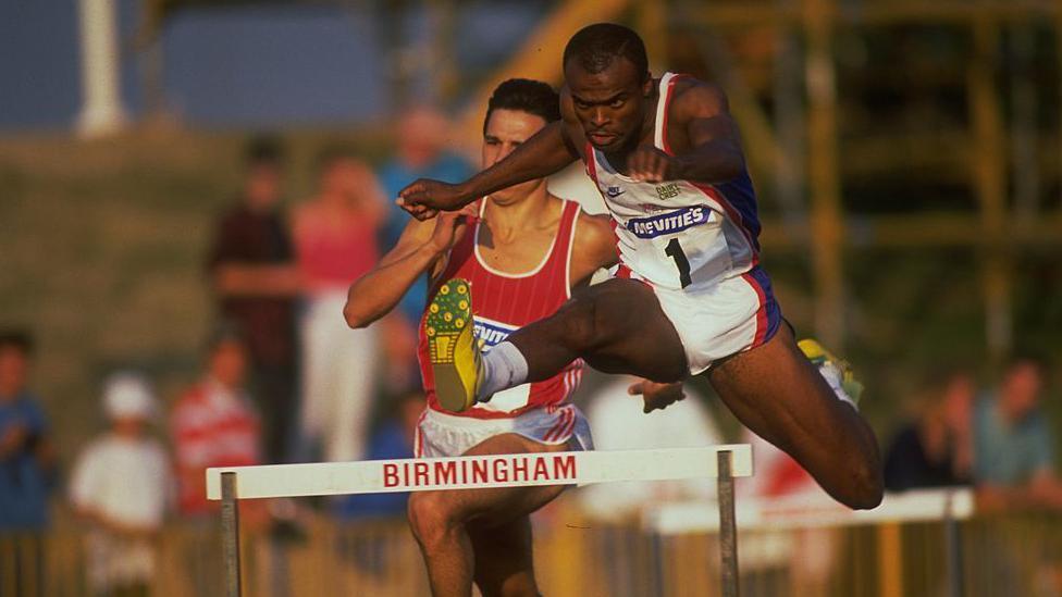 KRISS AKABUSI OF GREAT BRITAIN CLEARS A HURDLE IN THE 400 METRES HURDLES AT THE MCVITIES CHALLENGE HELD TODAY AT THE ALEXANDER STADIUM IN BIRMINGHAM, ENGLAND.