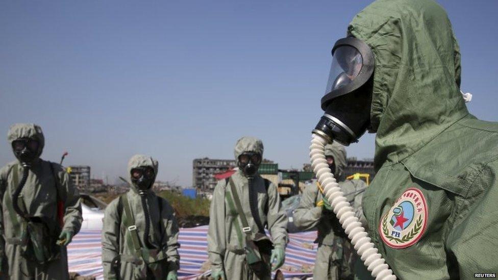 People's Liberation Army soldiers of the anti-chemical warfare corps are seen in protection suits at the site of last week's blasts in Tianjin (21 August 2015)