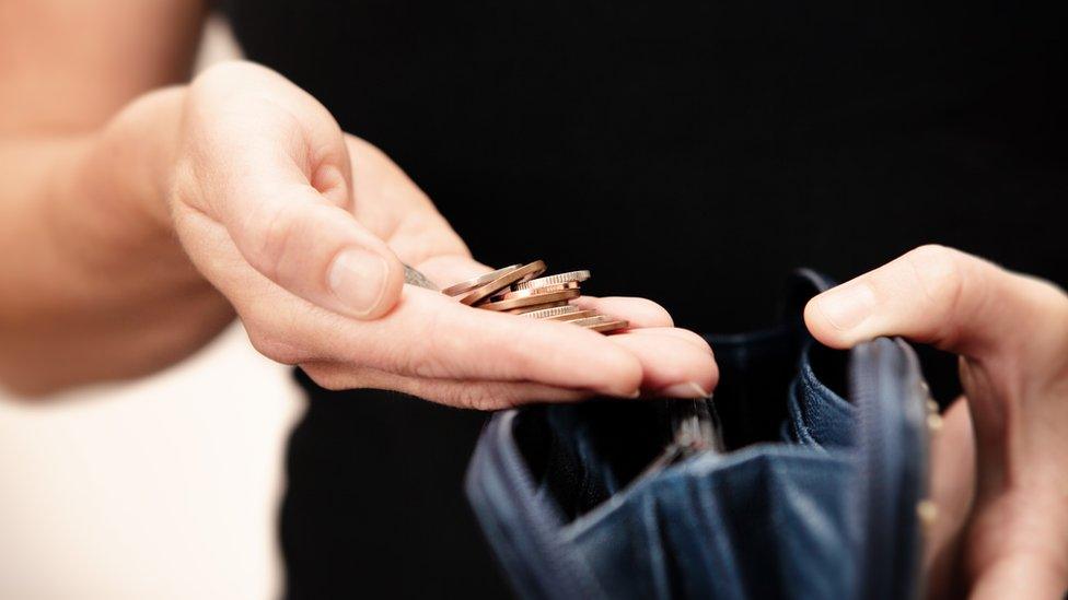 A woman's hand holding loose change