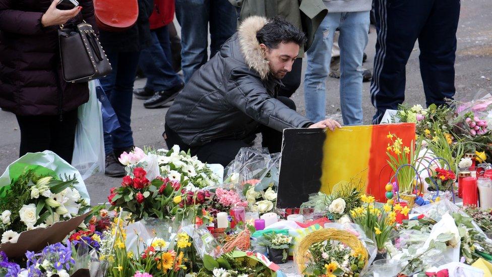People gather in the Place de la Bourse to pay tribute to the 31 victims of the attacks in Brussels last week on March 27, 2016