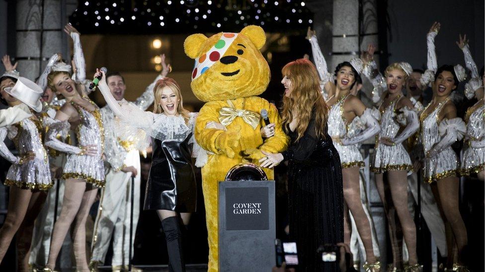 Kylie Minogue stands with Pudsey bear in Covent Garden for the turning on of the Christmas lights