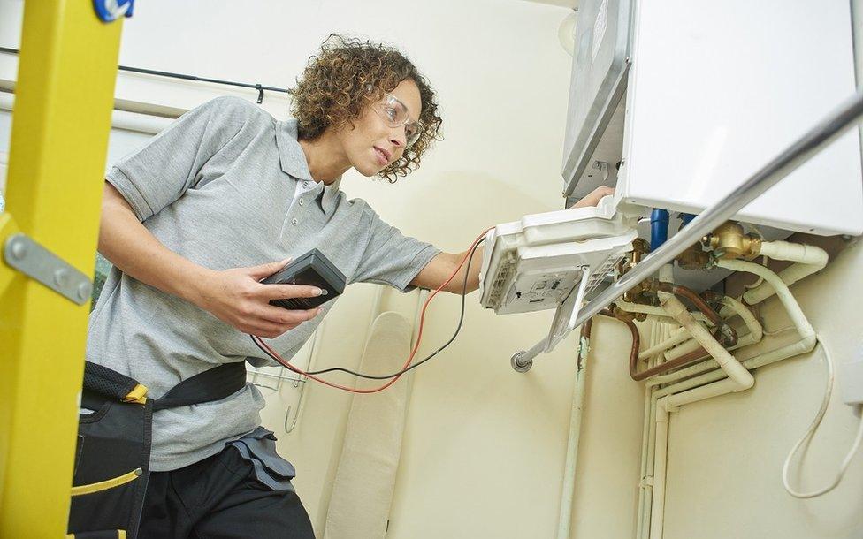 Engineer servicing a gas boiler