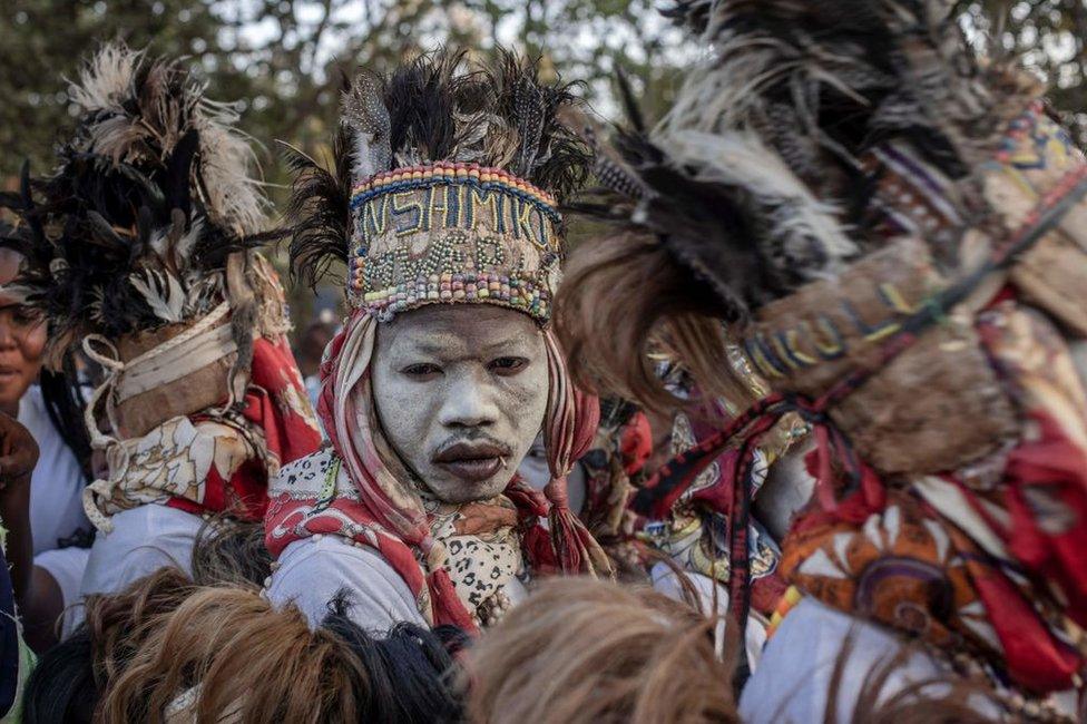 Traditional dancers perform as the remains of slain Congolese independence leader Patrice Lumumba arrive on June 26, 2022 in Shilatembo where the leader was killed along with two of his compatriots