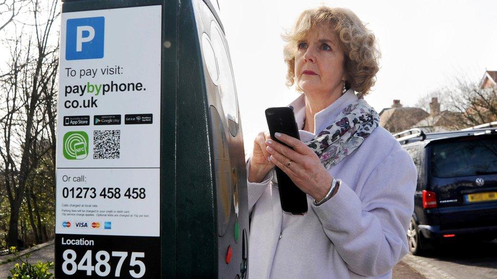 Woman at parking meter