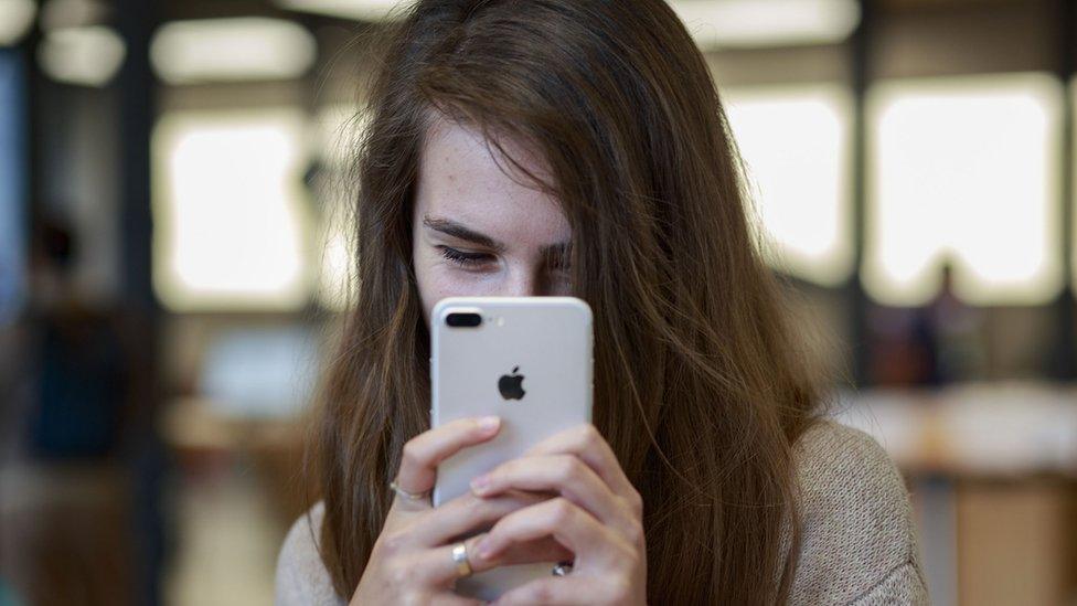 Woman takes a selfie with an iPhone