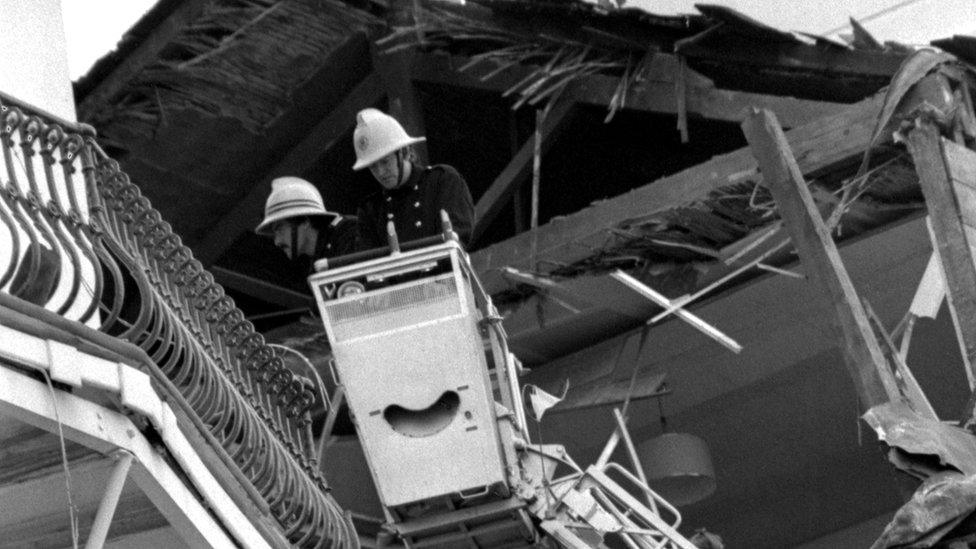 Firefighters inspect the hotel wreckage