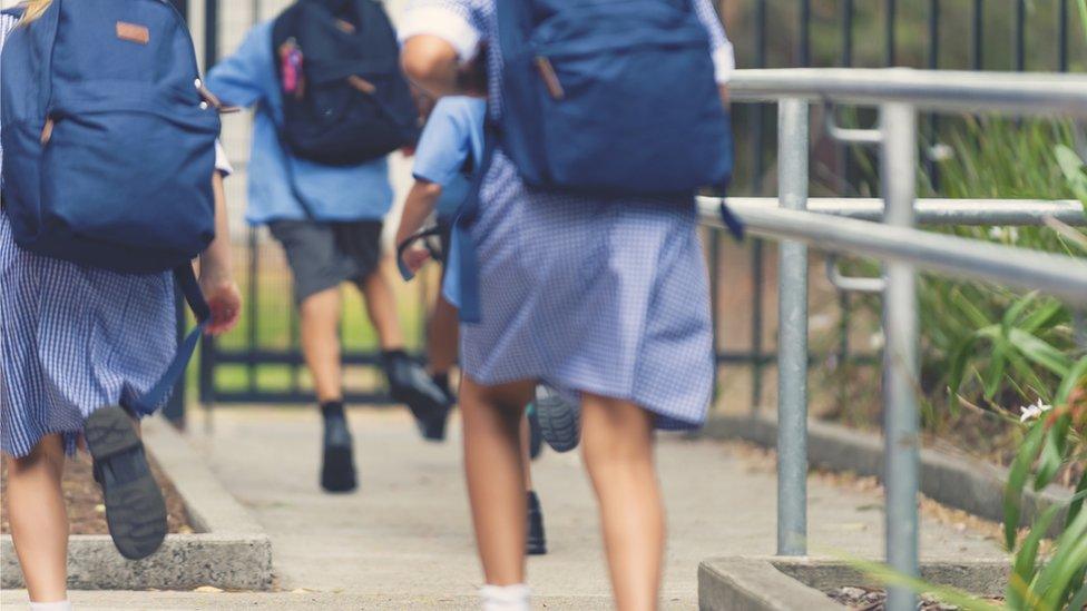 Children heading into school while wearing pyjamas