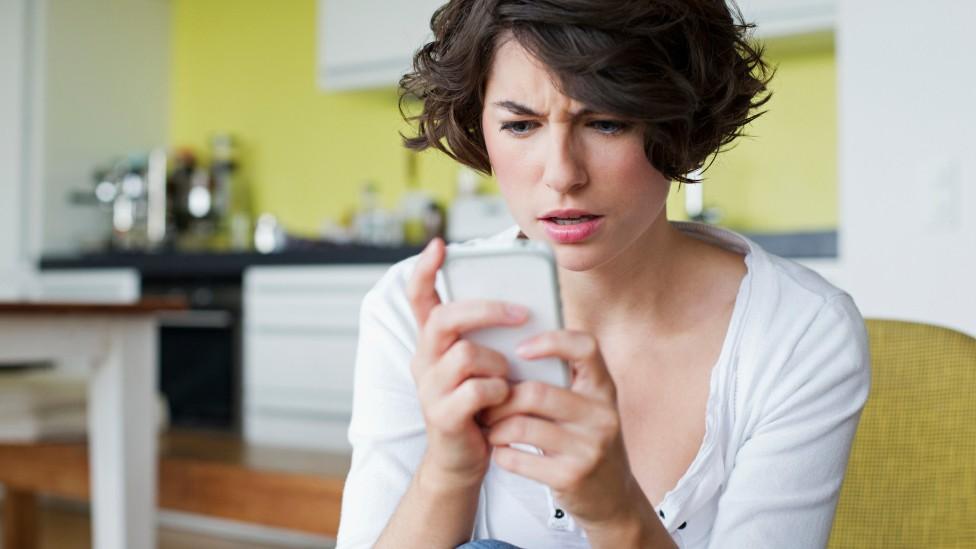 Woman irritated by her phone