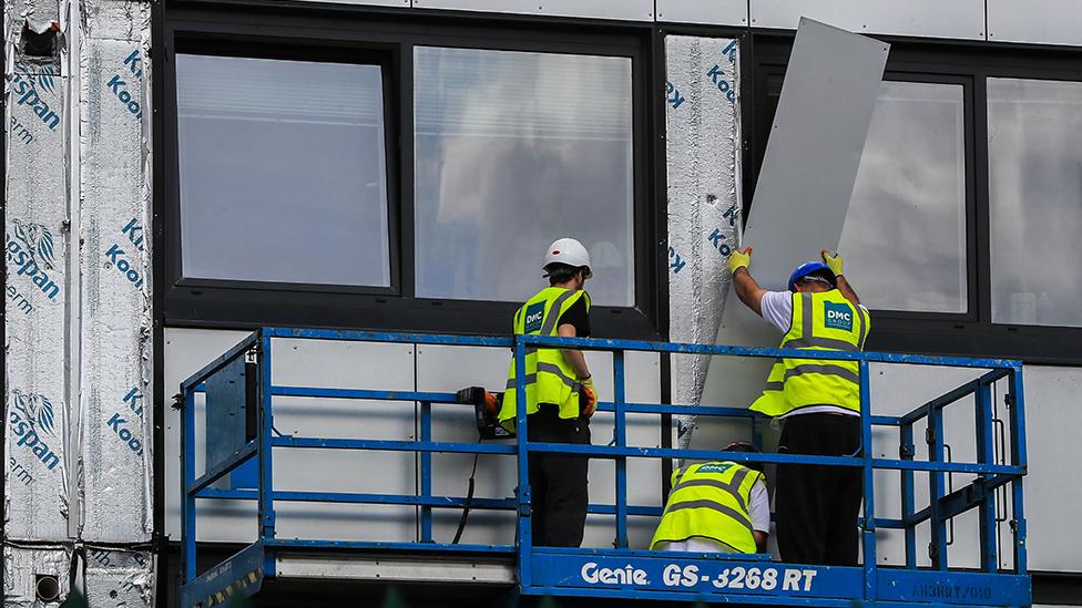 Cladding being removed from a building