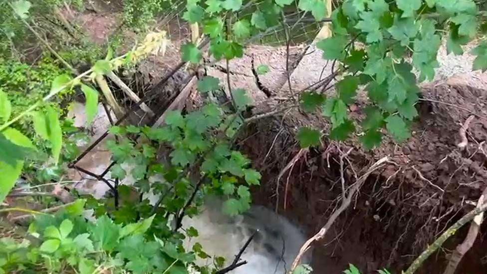 A breach on the embankment shows swirling water in the canalpton on Saturday led to a towpath collapsing