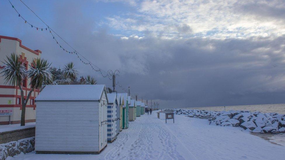 Snowy beach huts in Suffolk