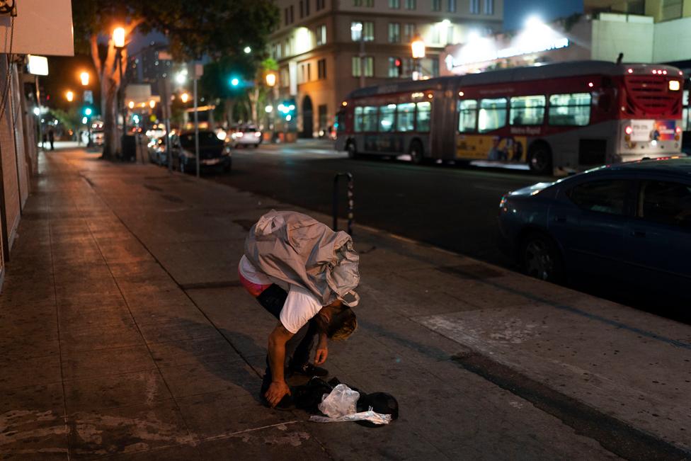 Anthony Delio, 36, falls asleep on a sidewalk after smoking fentanyl in Los Angeles, Tuesday, Aug. 23, 2022.