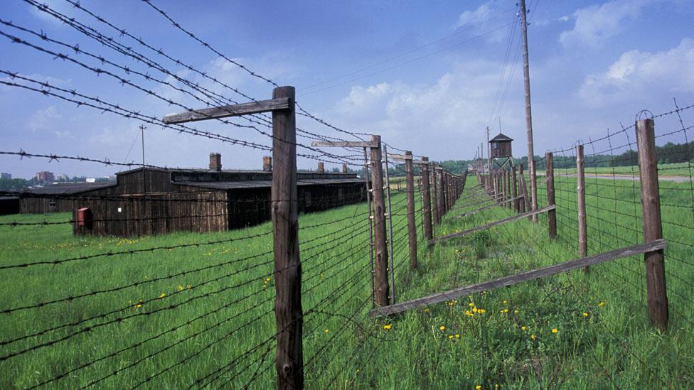 Barbed wire in a field protects a former concentration camp