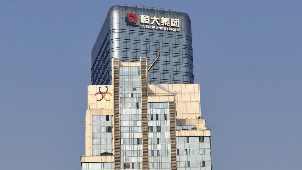 The logo of Evergrande Group is seen on the facade of a commercial building.